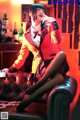 A woman sitting on a couch smoking a cigarette.