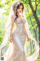 A woman in a wedding dress standing in the woods.