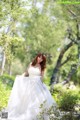 A woman in a wedding dress posing for a picture.